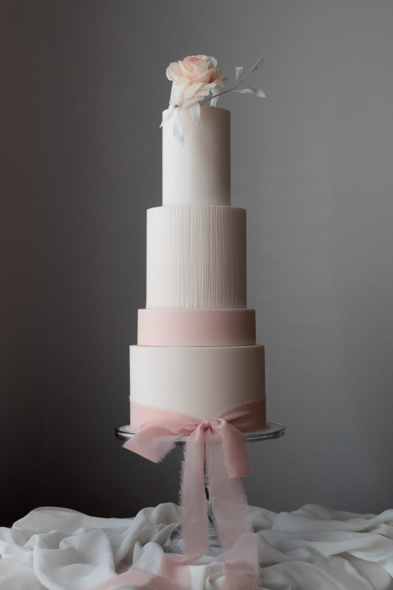 tall 3 tier wedding cake with pink sugar rose and pink ribbon and spacer tier-1