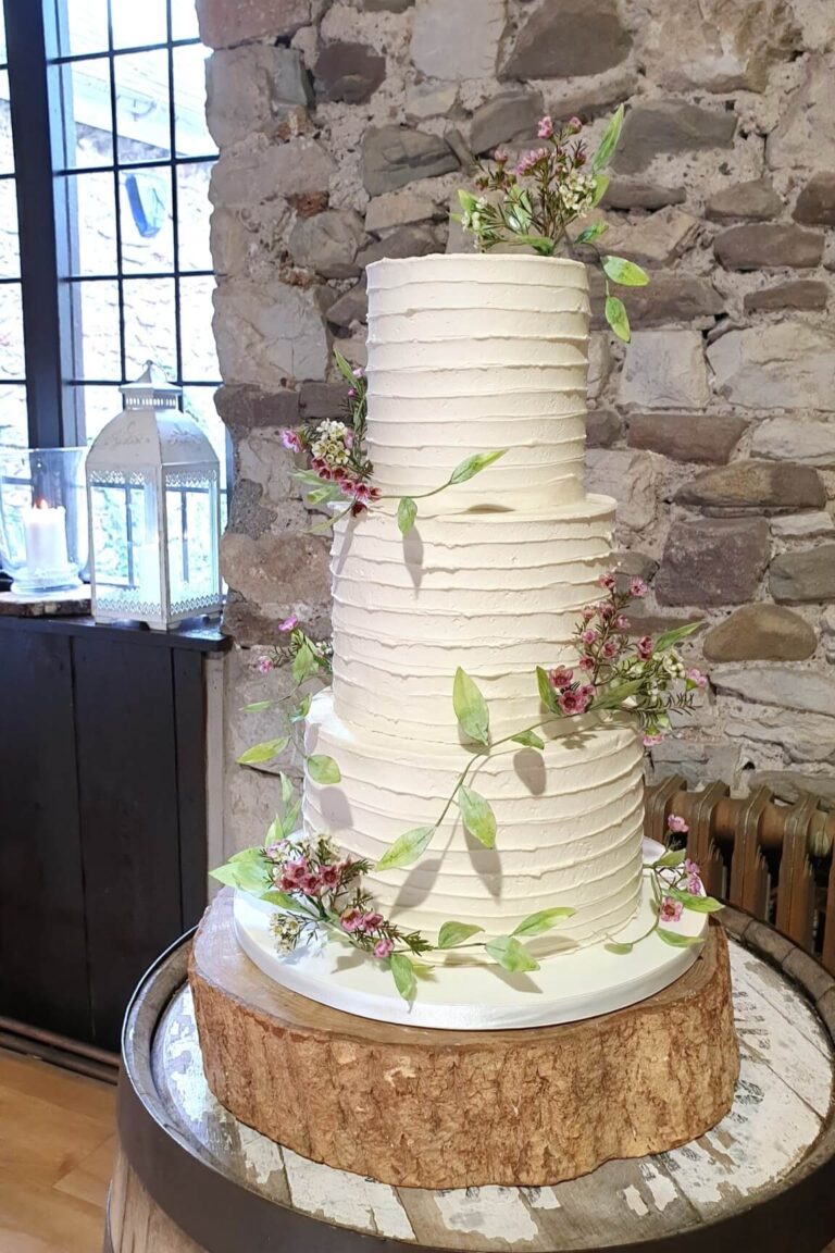 white 3 tier rustic floral wedding cake with textured buttercream