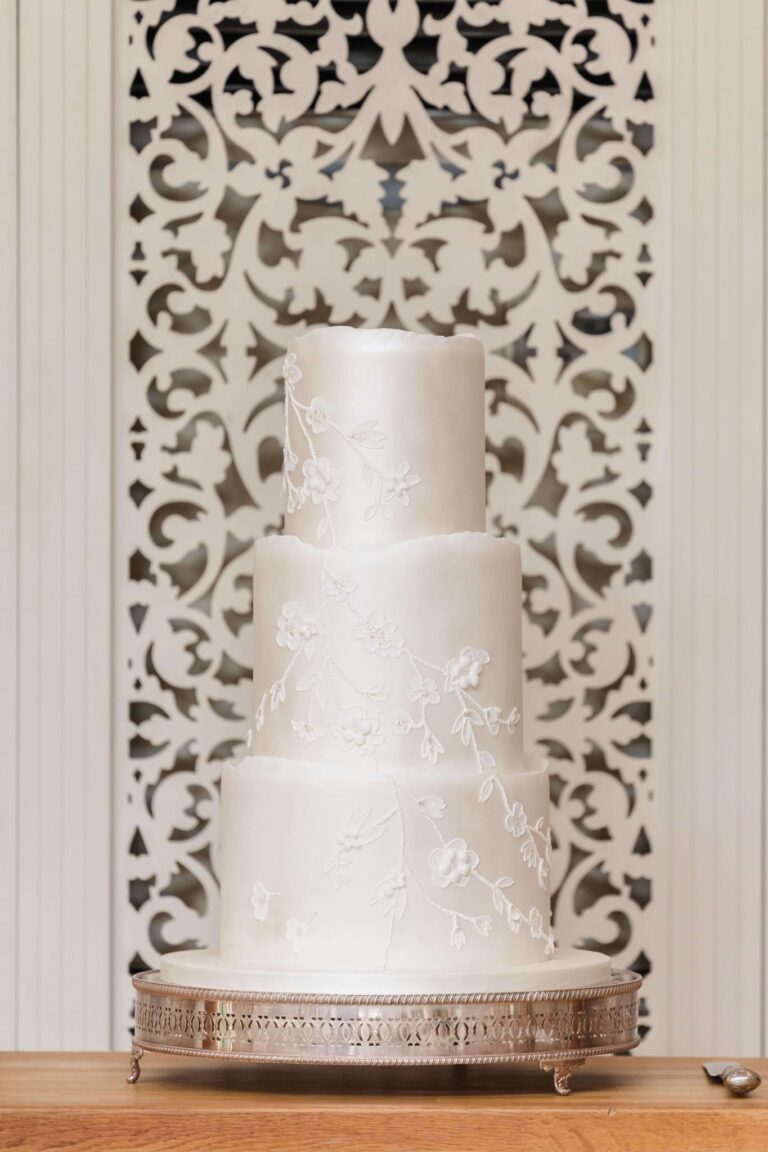 3 tier ivory pearl shimmer and lace wedding cake St Tewdrics