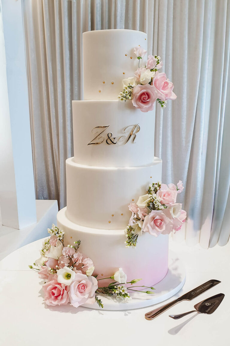 4 tier white and pink wedding cake with sugar and fresh flowers Vale Resort