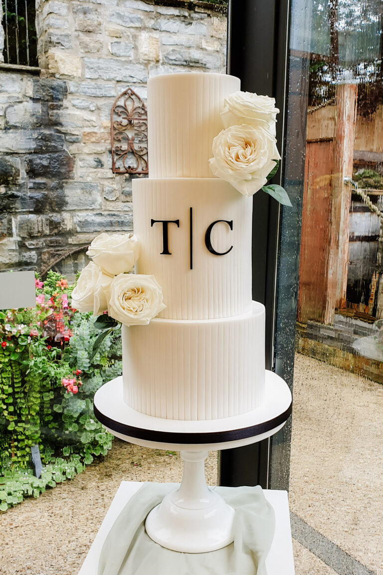 tall 3 tier white wedding cake with monogram and roses Pencoed House