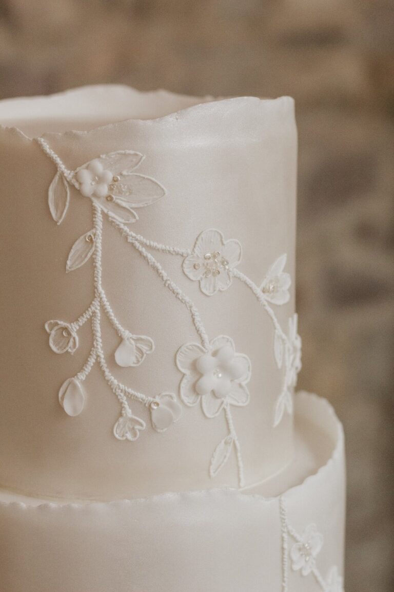 ivory pearl shimmer and piped lace wedding cake detail