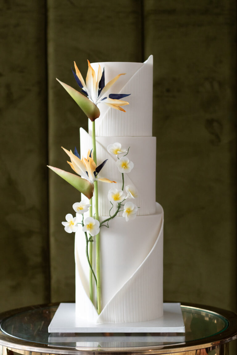 textured wrap wedding cake with wafer tropical florals