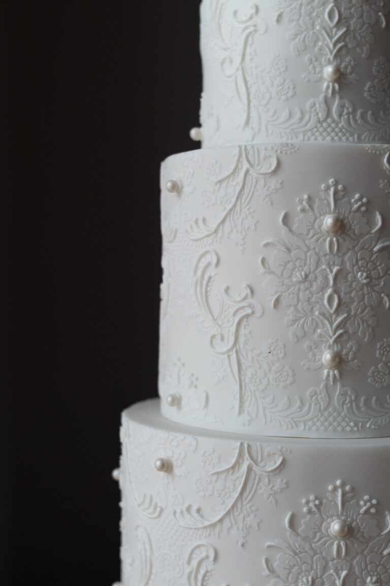 white stencil and hand piped lace wedding cake