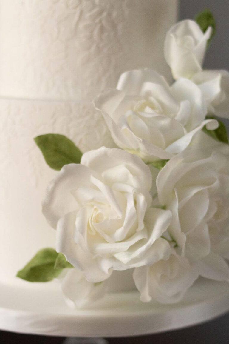 white wedding cake with handmade wafer paper roses